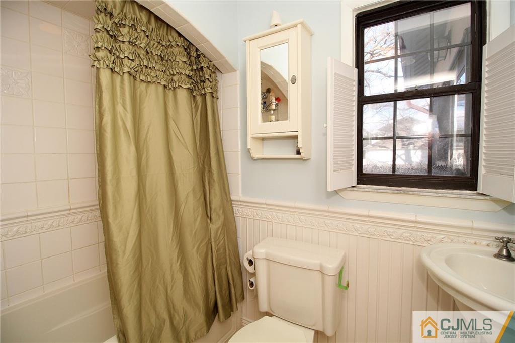 130 Ethel Road Edison, NJ 08817 - Photo 15 of 25 a bathroom with a sink and a shower curtain