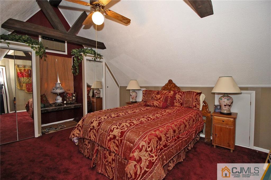 130 Ethel Road Edison, NJ 08817 - Photo 16 of 25 a bedroom with a bed and a chandelier
