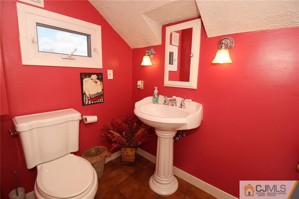 130 Ethel Road Edison, NJ 08817 - Photo 21 of 25 a bathroom with a toilet sink and mirror