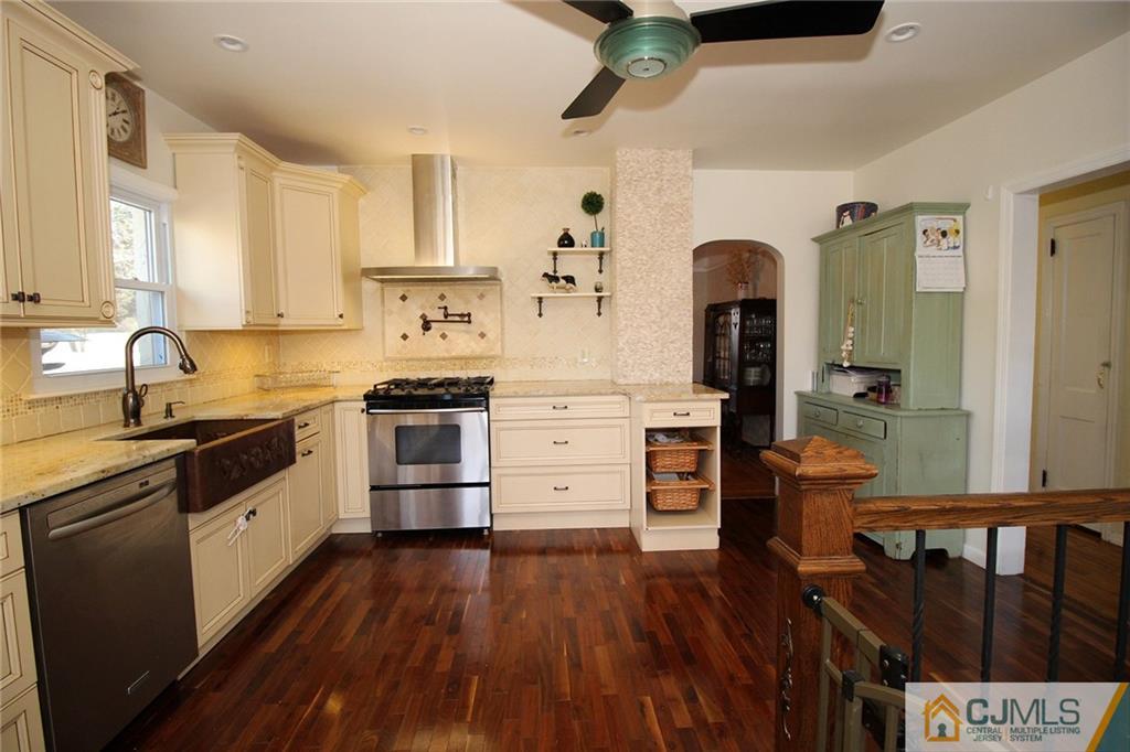 130 Ethel Road Edison, NJ 08817 - Photo 9 of 25 a kitchen with stainless steel appliances a stove top oven and a refrigerator