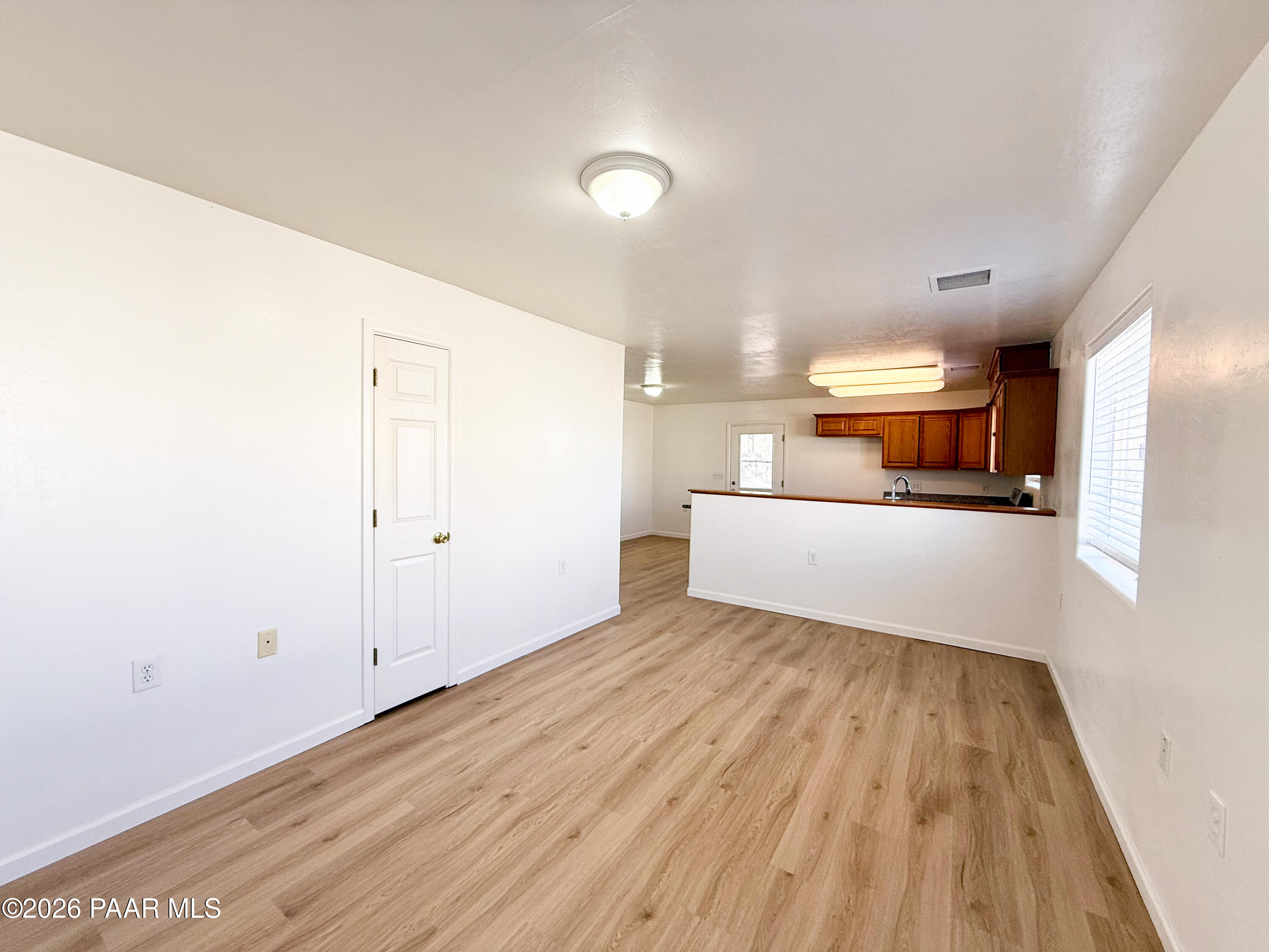 430 West Lake Louise Road Paulden, AZ 86334 - Photo 3 of 19 a view of a room with wooden floor and white walls
