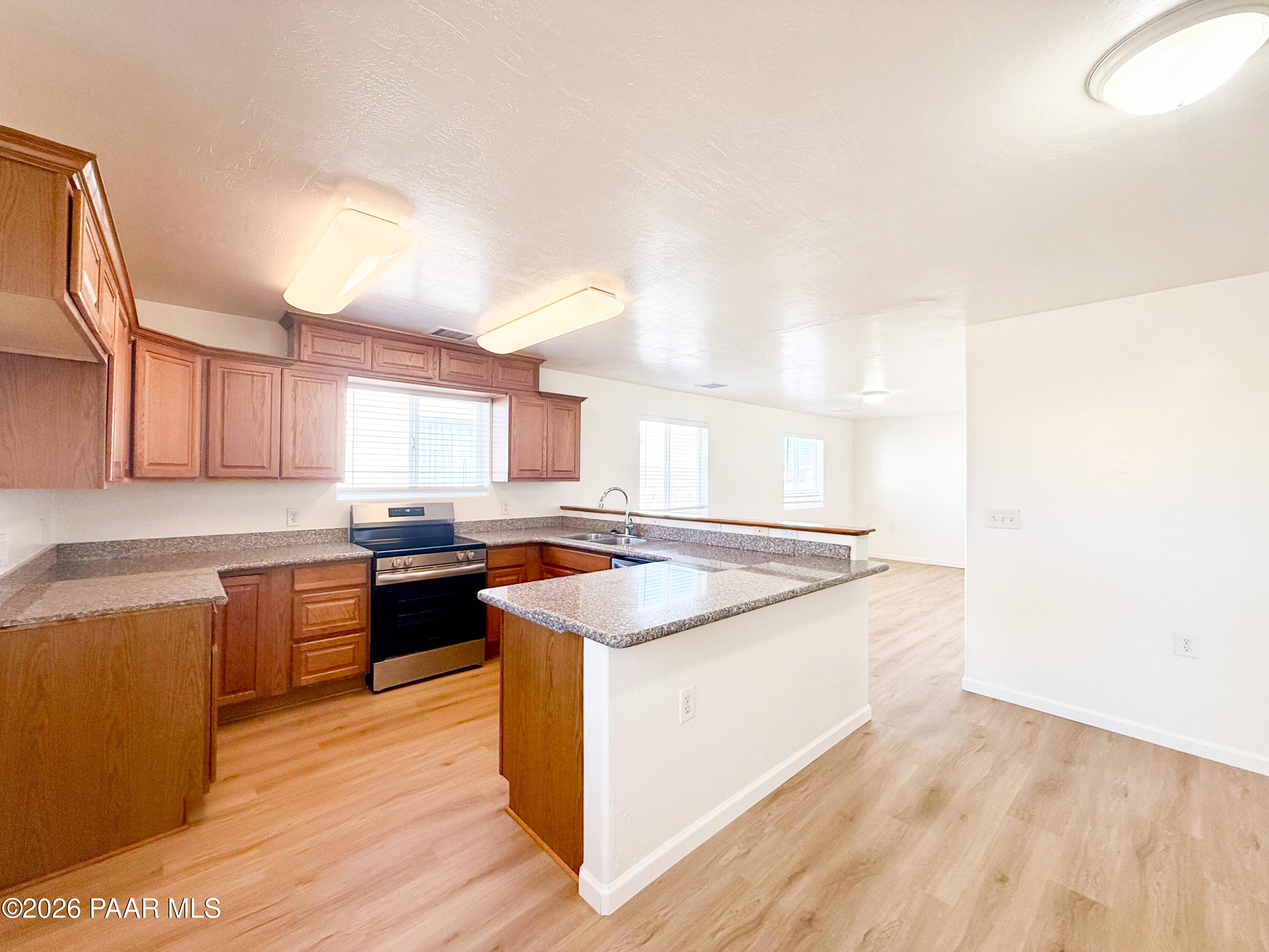430 West Lake Louise Road Paulden, AZ 86334 - Photo 4 of 19 a kitchen with stainless steel appliances granite countertop a stove and a sink
