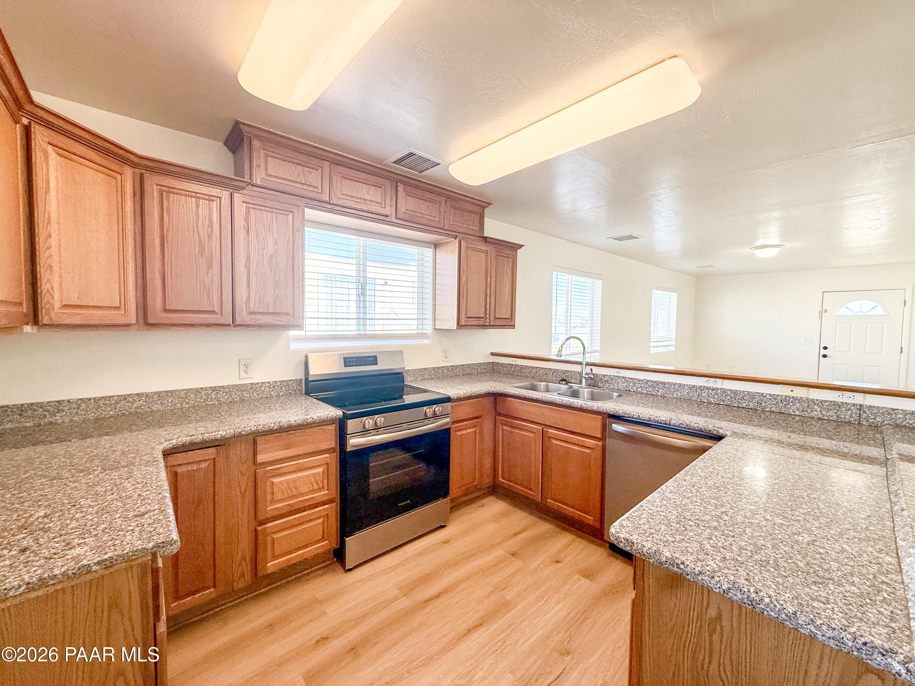 430 West Lake Louise Road Paulden, AZ 86334 - Photo 5 of 19 a kitchen with stainless steel appliances granite countertop wooden cabinets and a granite counter tops with a large window