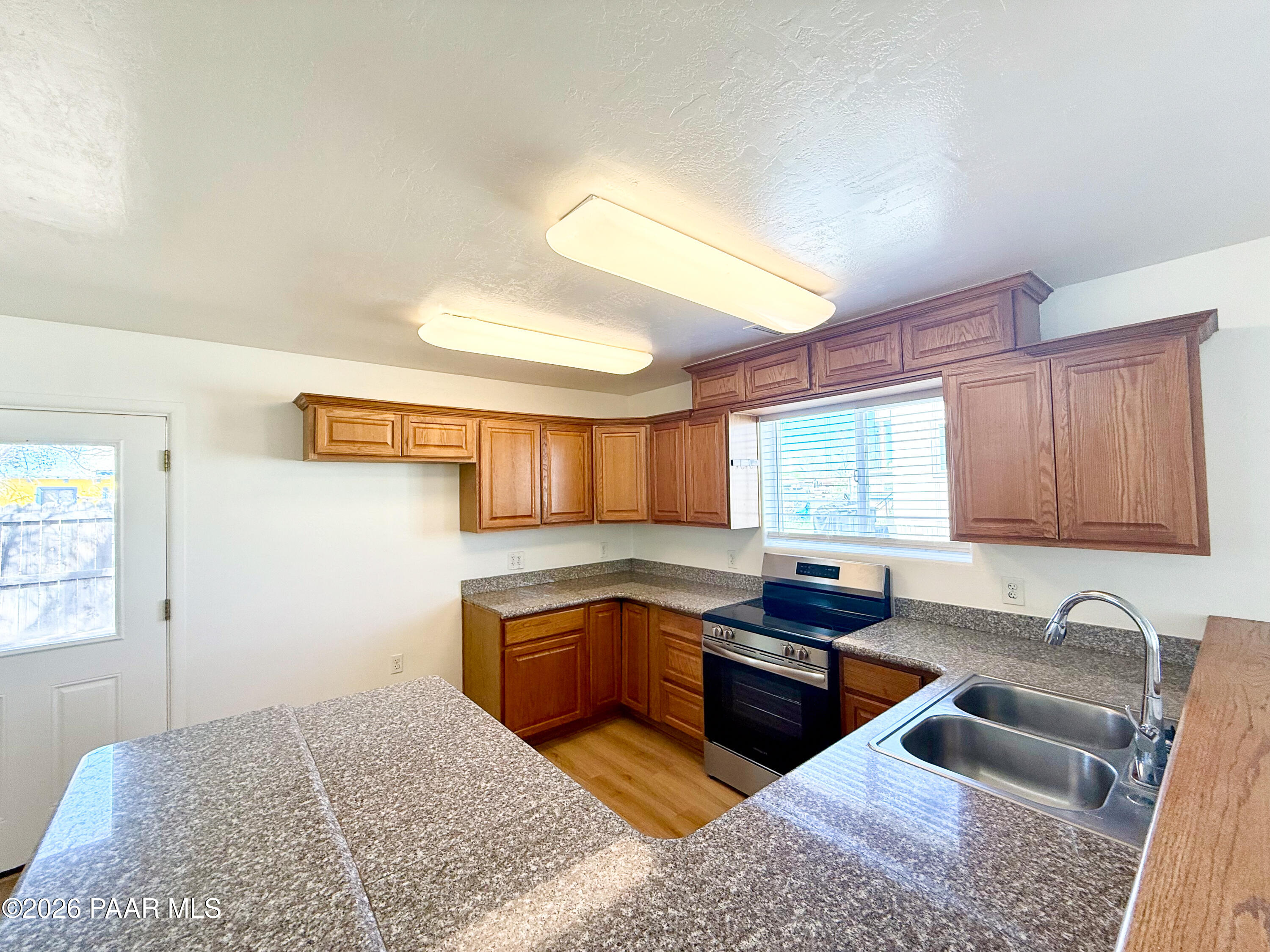 430 West Lake Louise Road Paulden, AZ 86334 - Photo 6 of 19 a kitchen with granite countertop a sink and a stove top oven
