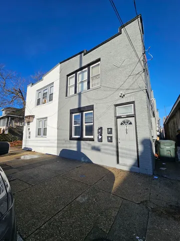 a front view of a building with a yard