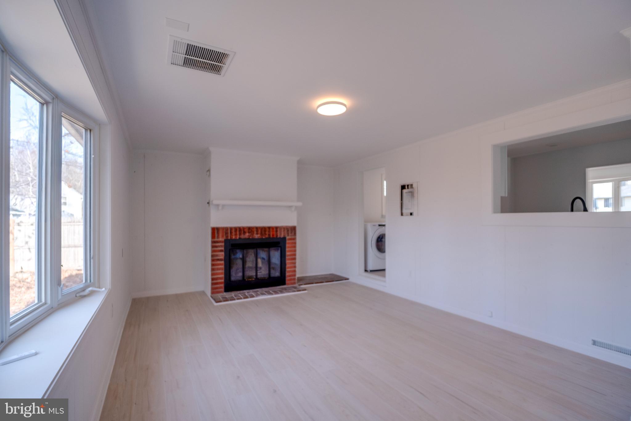 1302 Edgewood Avenue Westville, NJ 08093 - Photo 13 of 16 a view of an empty room with a window and fireplace