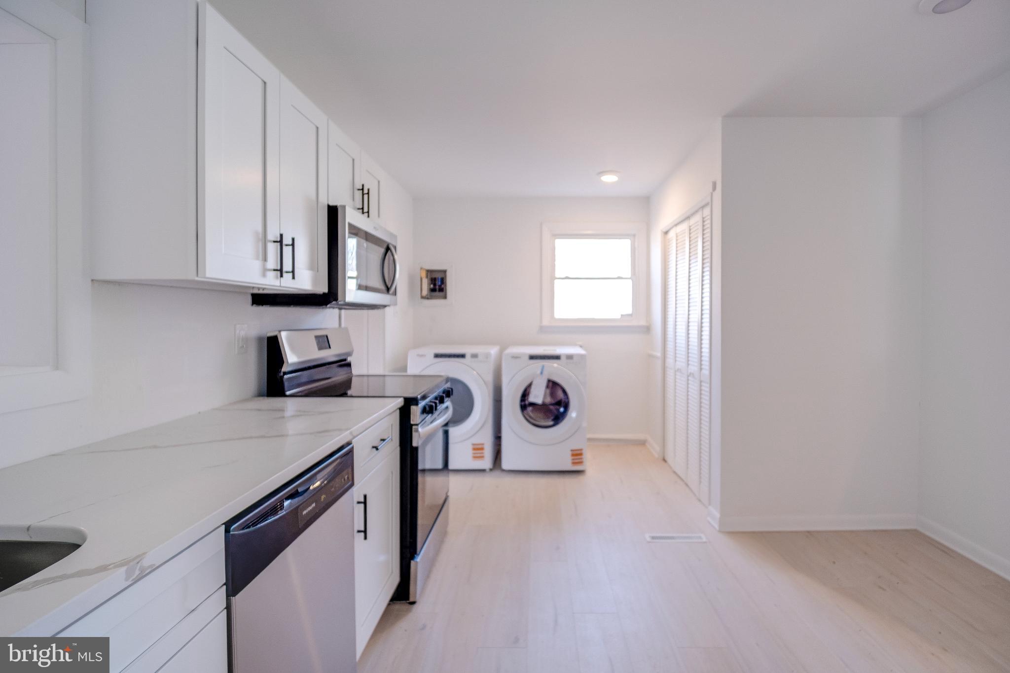 1302 Edgewood Avenue Westville, NJ 08093 - Photo 7 of 16 a kitchen with stainless steel appliances granite countertop a stove a sink and a refrigerator