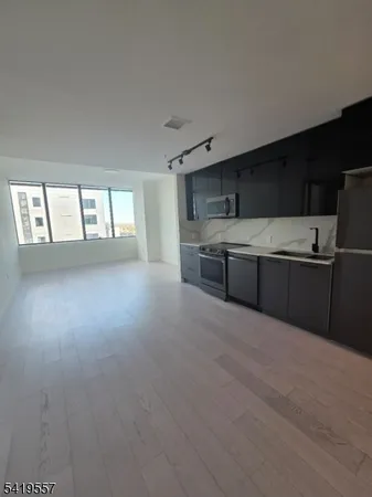 a view of kitchen with cabinets and wooden floor