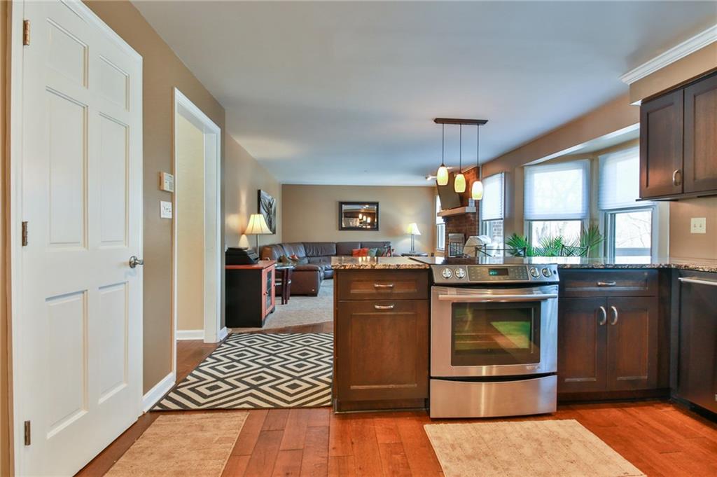 556 Center Church Road Canonsburg, PA 15317 - Photo 11 of 18 Beautifully updated kitchen with new hardwood flooring, granite counter tops, hardwood cabinets, and stainless steel appliances.