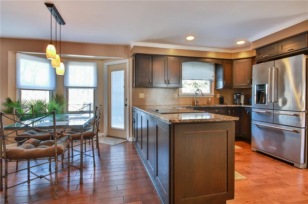 556 Center Church Road Canonsburg, PA 15317 - Photo 10 of 18 Beautifully updated kitchen with new hardwood flooring, granite counter tops, hardwood cabinets, and stainless steel appliances.