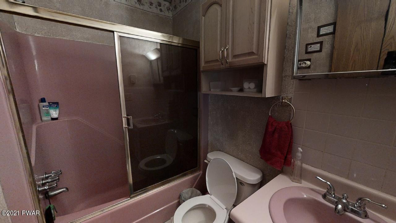 133 Skyview Road Dingmans Ferry, PA 18328 - Photo 6 of 15 a bathroom with a sink mirror vanity and toilet