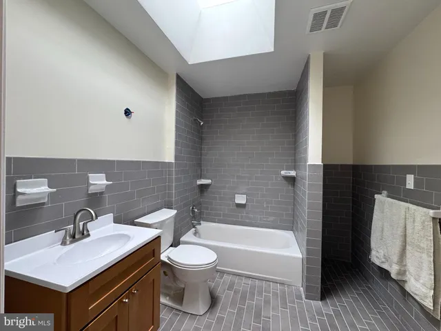 a bathroom with a sink a toilet and tub