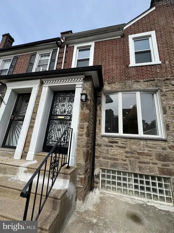 a view of a brick house with many windows