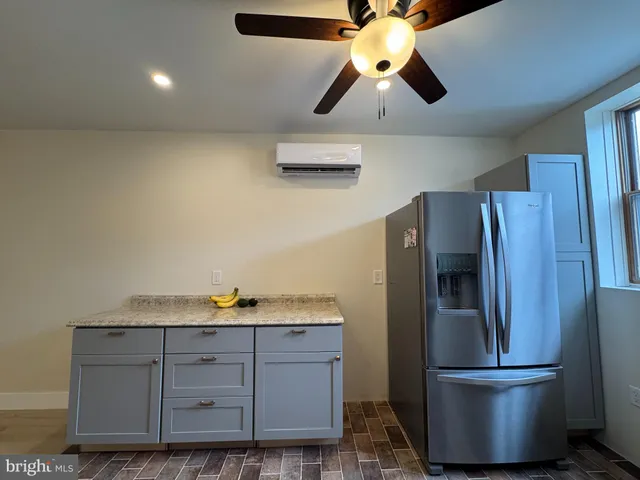 a kitchen with a refrigerator and microwave