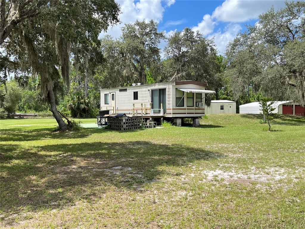 820 Chicken Farm Road Osteen, FL 32764 - Photo 11 of 30 a front view of a house with a garden