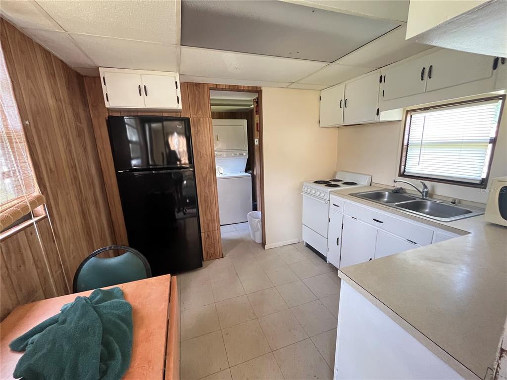 820 Chicken Farm Road Osteen, FL 32764 - Photo 12 of 30 a kitchen with stainless steel appliances kitchen island a refrigerator sink and stove