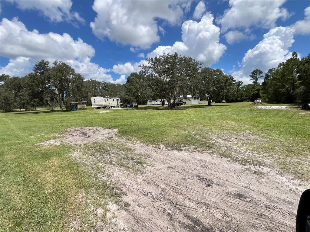 820 Chicken Farm Road Osteen, FL 32764 - Photo 24 of 30 a view of a big yard with plants and large trees