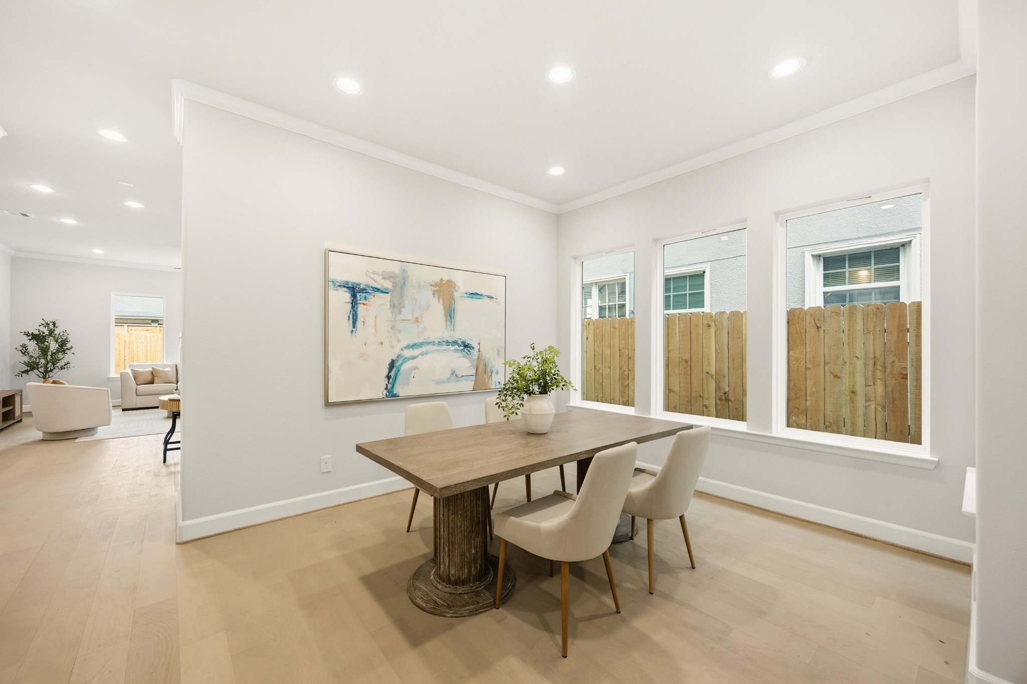 4317 Roseland Street, Unit B Houston, TX 77006 - Photo 11 of 29 Dine under the soft embrace of daylight, with a wall of windows inviting the outside in.