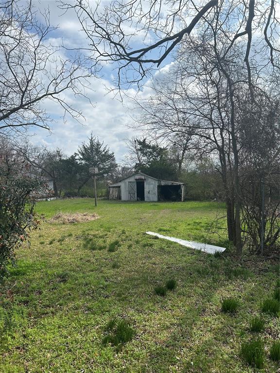 509 Allen Avenue Bonham, TX 75418 - Photo 3 of 9 View of grassy yard featuring an outbuilding and a pole building