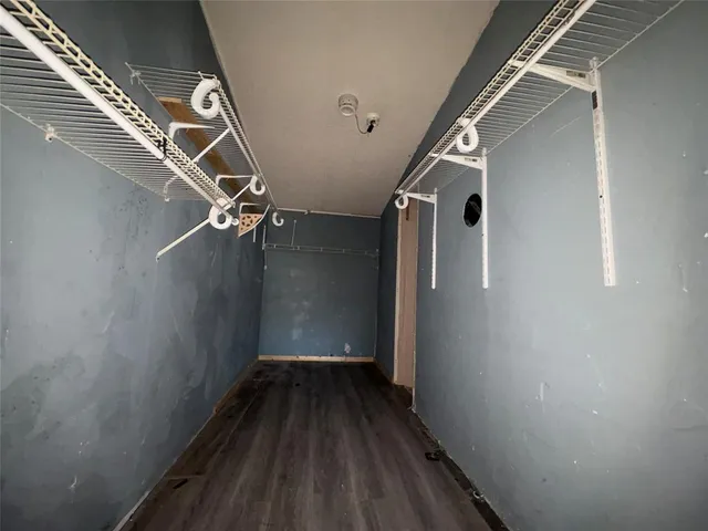 a view of a room with wooden floor