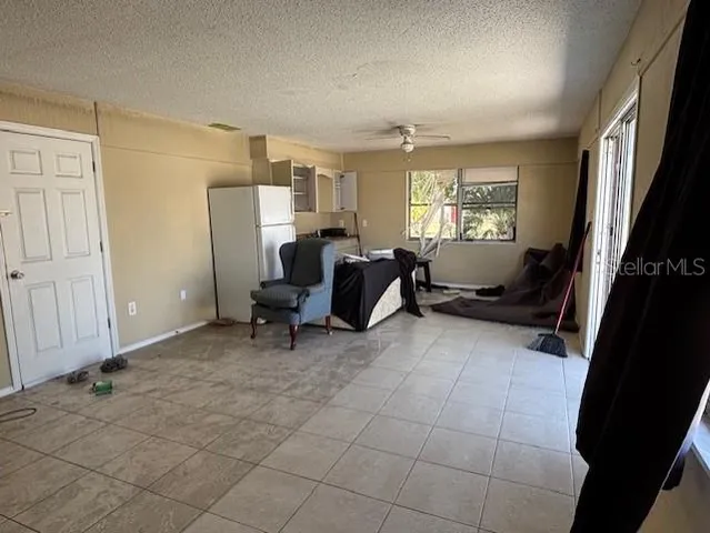 a view of a livingroom with workspace and a window