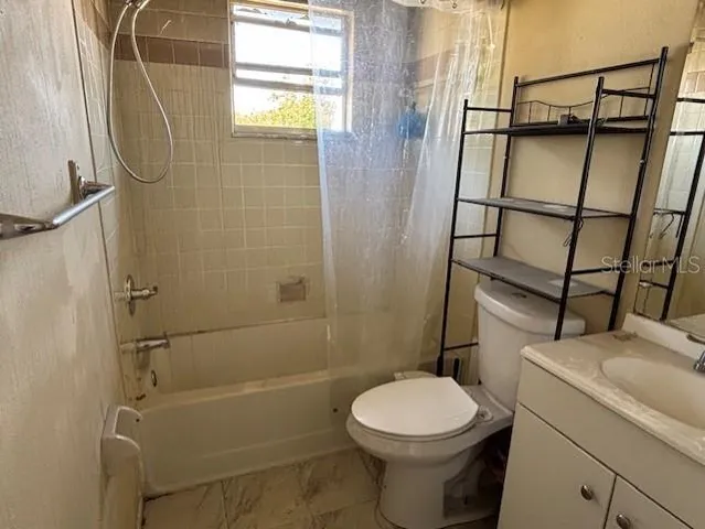 a bathroom with a toilet and shower
