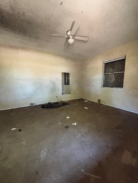 3538 Pinetree Street Port Charlotte, FL 33952 - Photo 17 of 28 an empty room with a ceiling fan and window