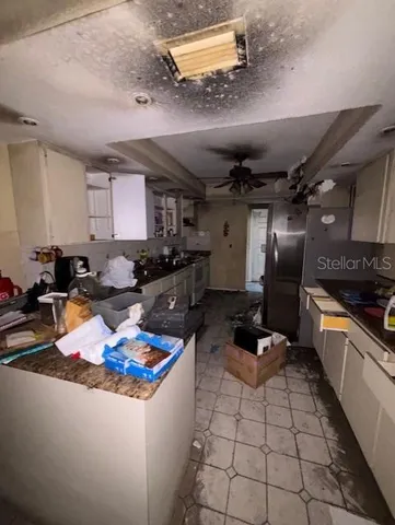 a kitchen with a sink appliances and cabinets