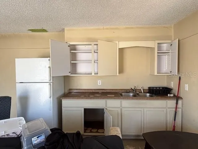 a kitchen with a sink appliances and cabinets