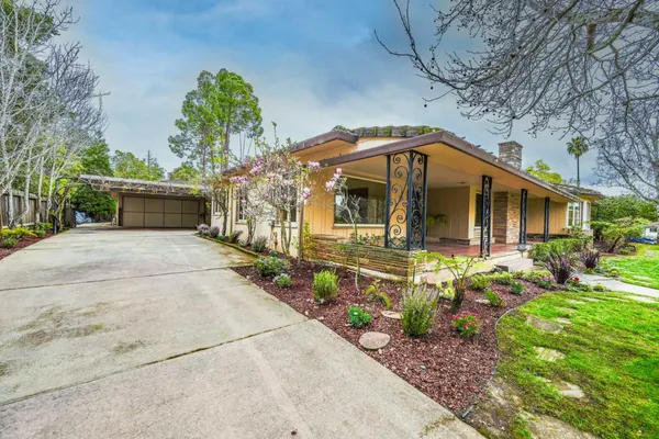 a front view of a house with garden