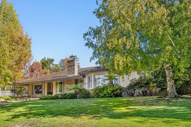 a front view of a house with a garden