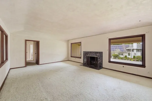 a view of empty room with a fireplace