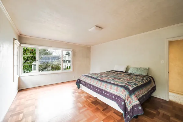 a bedroom with a bed and a window