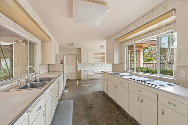 a kitchen with a sink stove and cabinets