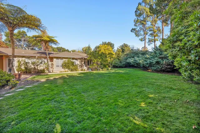 a view of green field with house in the background