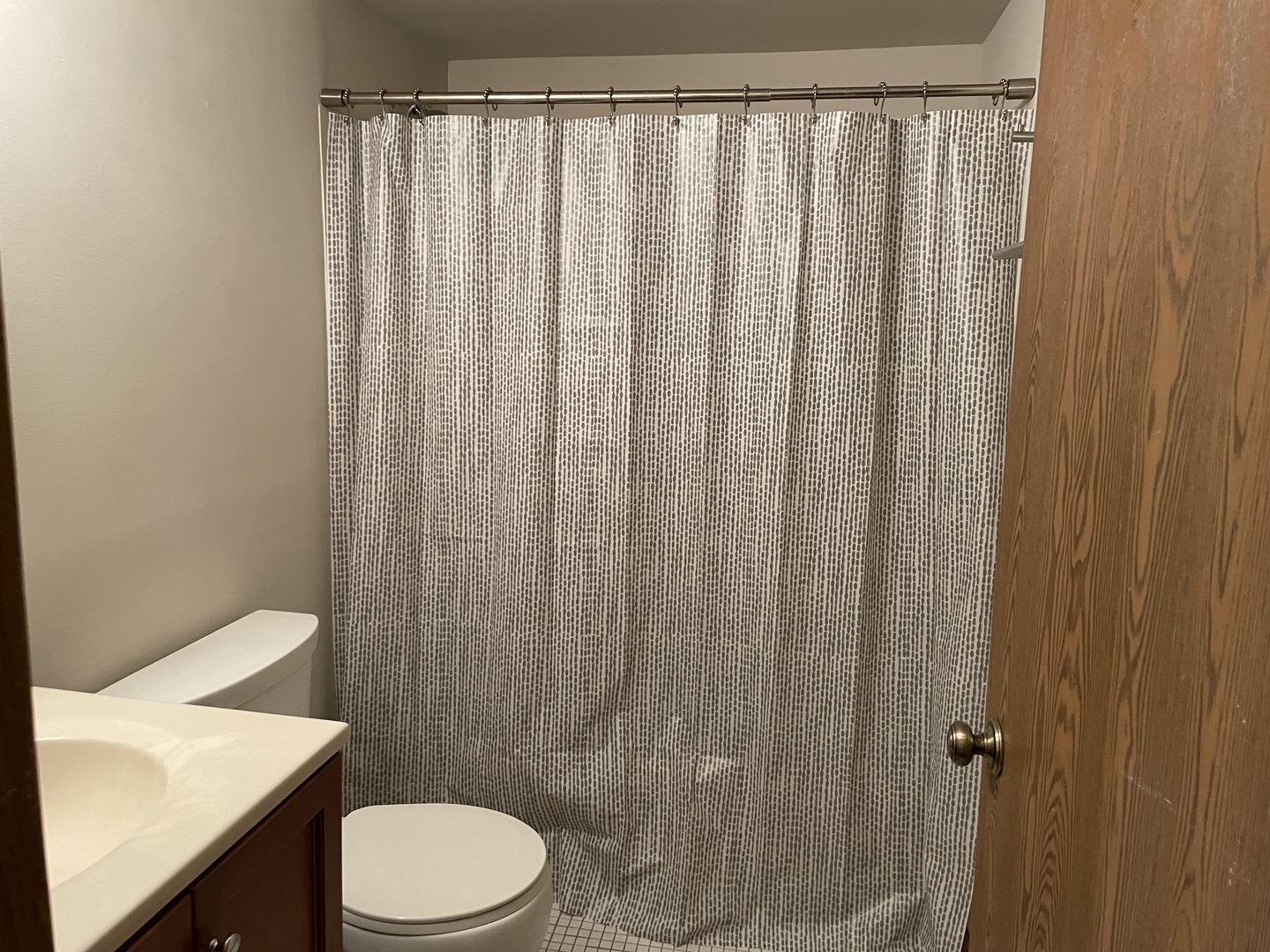 976 North Rohlwing Road, Unit GA Addison, IL 60101 - Photo 12 of 20 a white toilet sitting next to a shower curtain