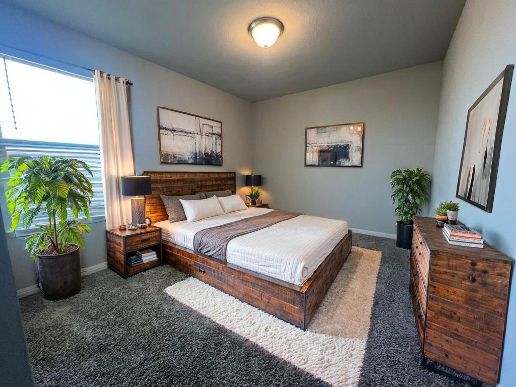 124 Old Stagecoach Road Jarrell, TX 76537 - Photo 20 of 40 a bedroom with a bed and a potted plant