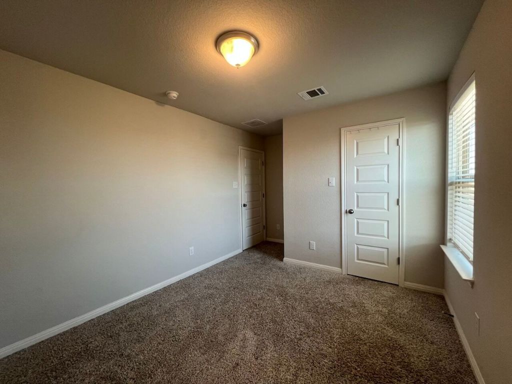 124 Old Stagecoach Road Jarrell, TX 76537 - Photo 22 of 40 an empty room with windows and closet