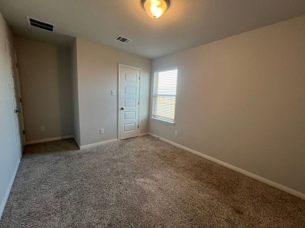 124 Old Stagecoach Road Jarrell, TX 76537 - Photo 23 of 40 an empty room with windows & cabinet in it