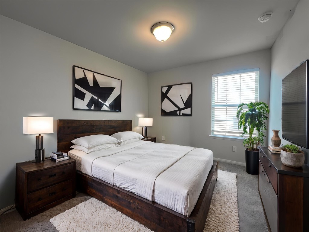 124 Old Stagecoach Road Jarrell, TX 76537 - Photo 24 of 40 a bedroom with a bed and a potted plant