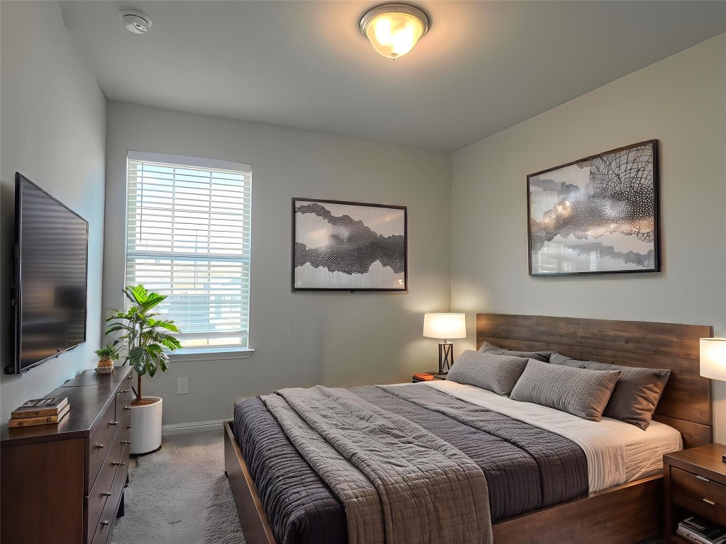 124 Old Stagecoach Road Jarrell, TX 76537 - Photo 27 of 40 a bedroom with bed and a potted plant