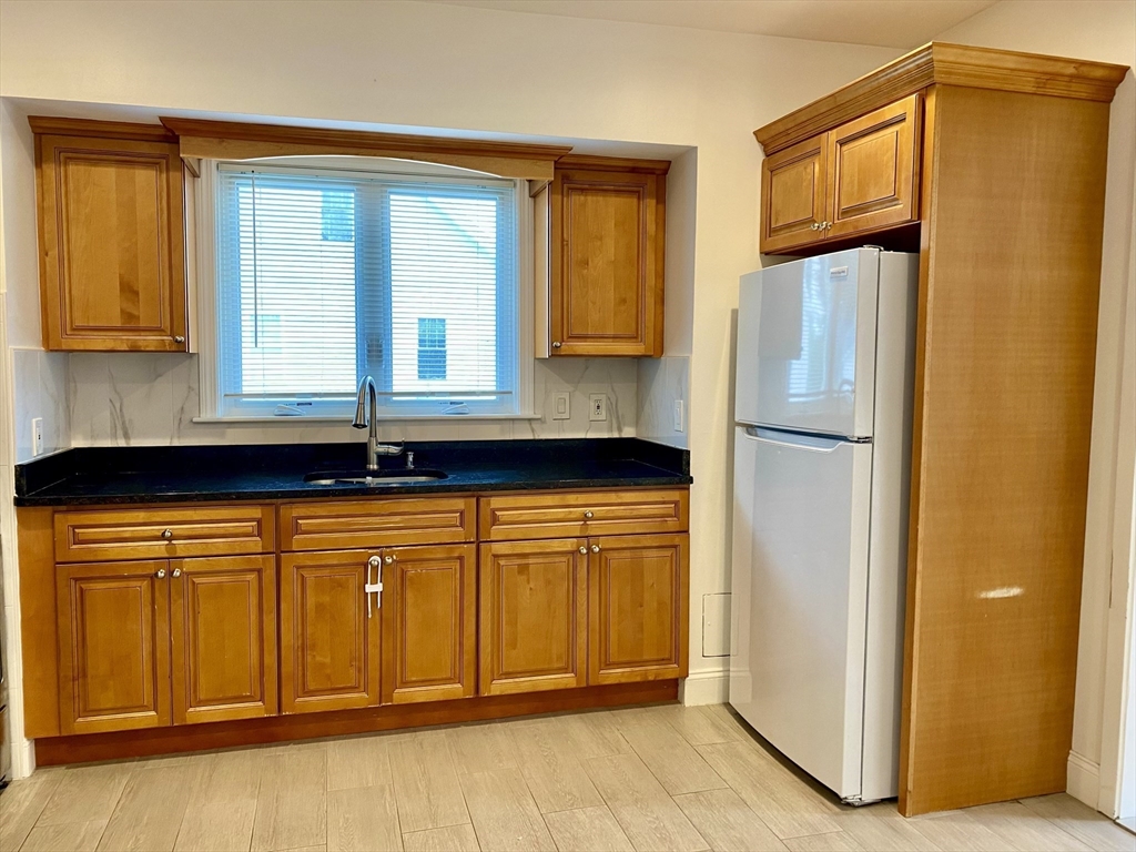 21 Heldun Street, Unit 2 Boston, MA 02132 - Photo 3 of 19 a kitchen with stainless steel appliances granite countertop a refrigerator and a sink