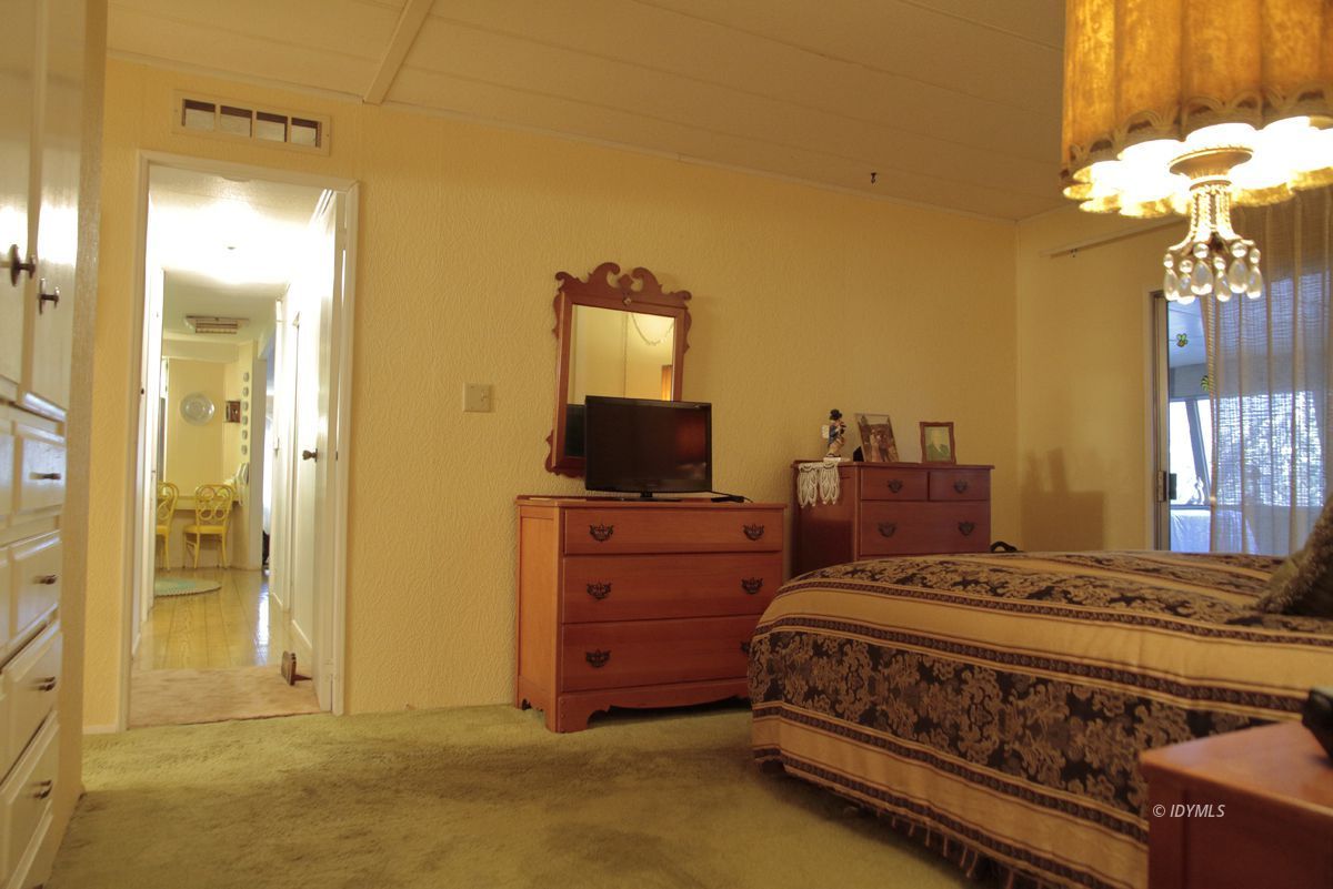 46 Pine Cove Road Idyllwild, CA 92549 - Photo 23 of 24 a bedroom with a bed and a chandelier