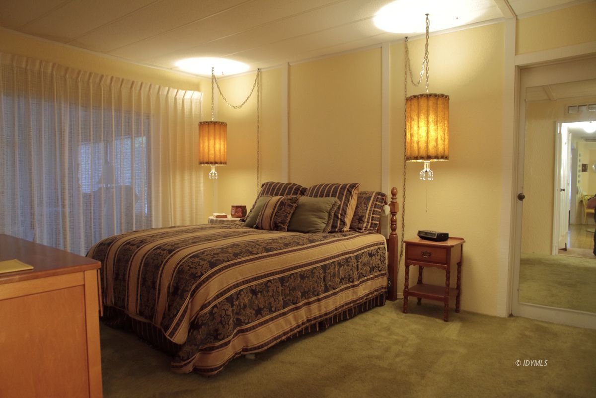 46 Pine Cove Road Idyllwild, CA 92549 - Photo 6 of 24 a bedroom with a bed and a chandelier