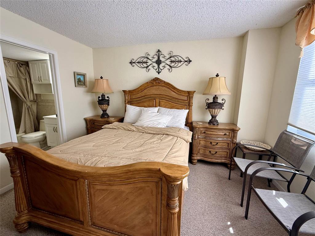 101 Briny Avenue, Unit 2604 Pompano Beach, FL 33062 - Photo 12 of 31 a bedroom with a bed and wooden floor