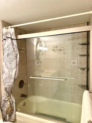 a bathroom with a bathtub and shower