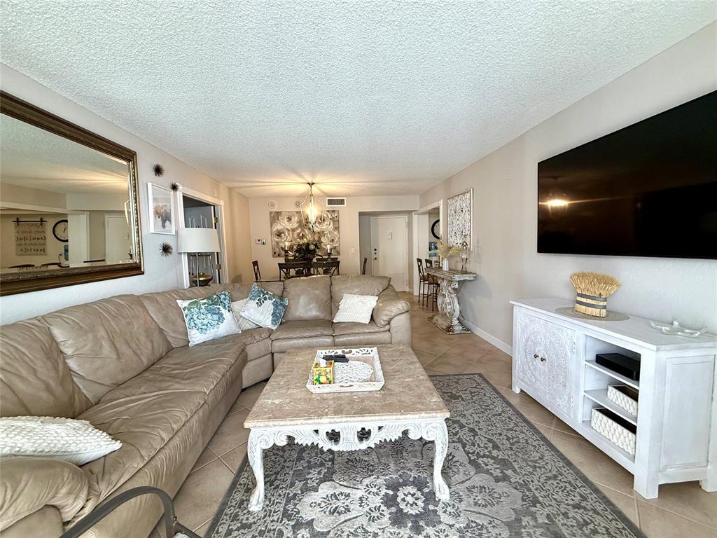 101 Briny Avenue, Unit 2604 Pompano Beach, FL 33062 - Photo 3 of 31 a living room with furniture and a flat screen tv