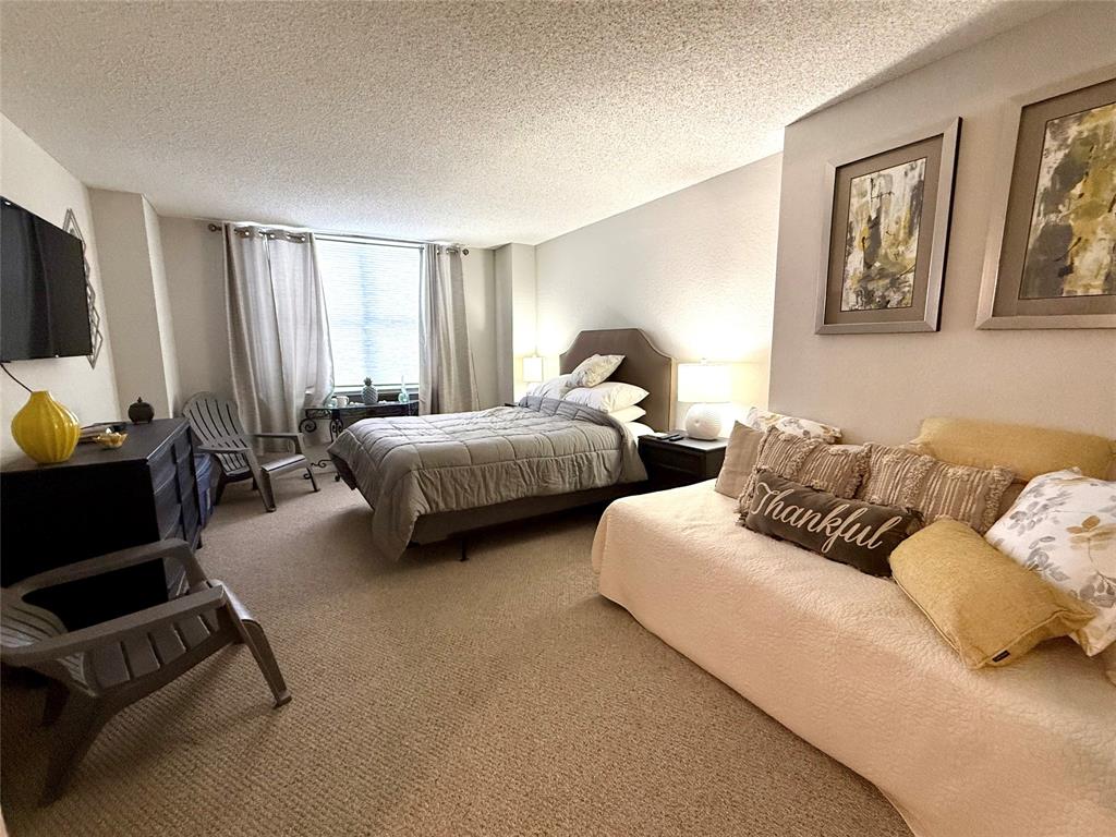 101 Briny Avenue, Unit 2604 Pompano Beach, FL 33062 - Photo 9 of 31 a bedroom with two beds and a couch