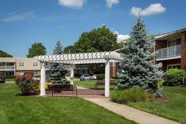a view of a chair and tables in the backyard of the house