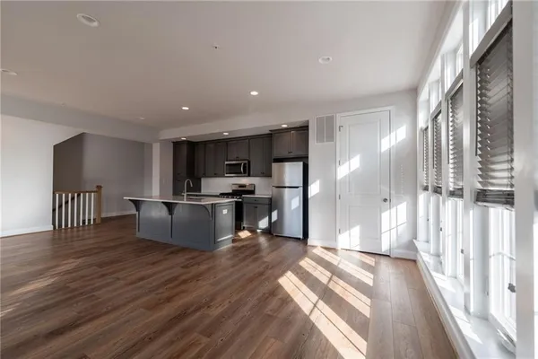 a view of kitchen with kitchen island microwave and stove